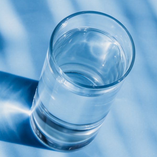 Glass of water on a blue background